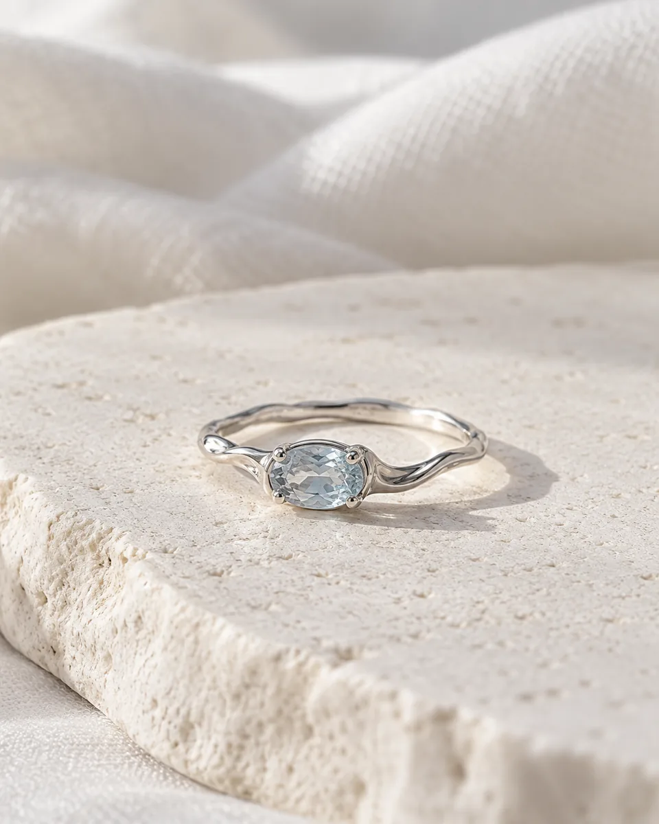 Concept: pale blue crystal ring on light natural stone